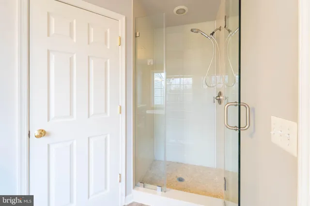 a bathroom with a granite countertop sink a mirror and a shower
