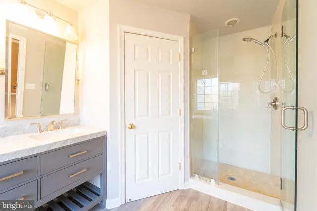 a bathroom with a glass shower door