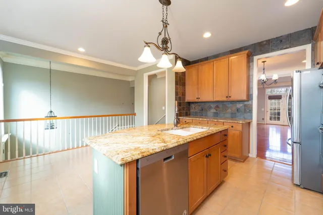 a bathroom with a granite countertop sink and a large mirror