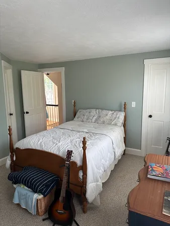 a bedroom with a bed and window