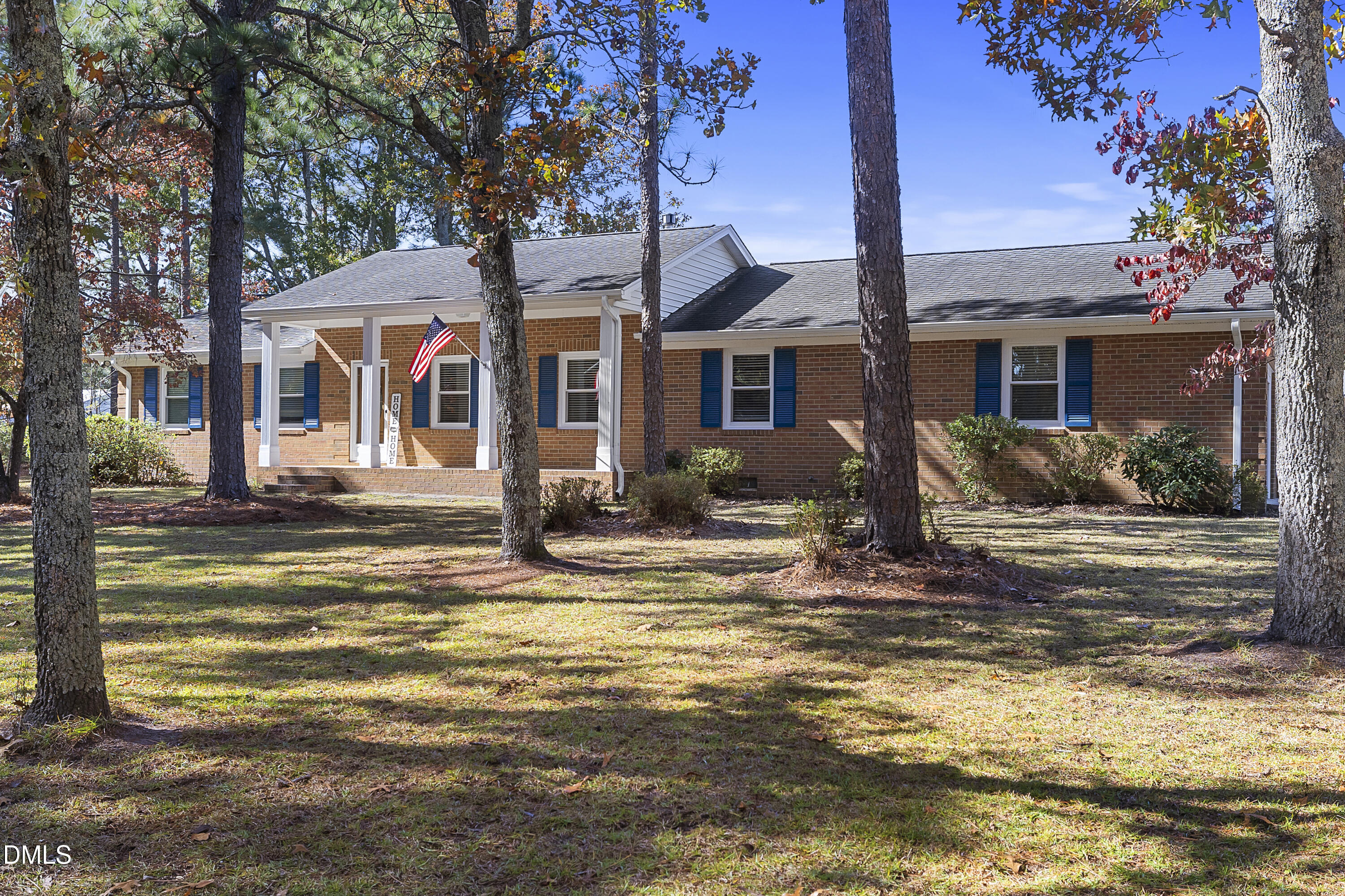 a front view of a house with a porch patio and fire pit