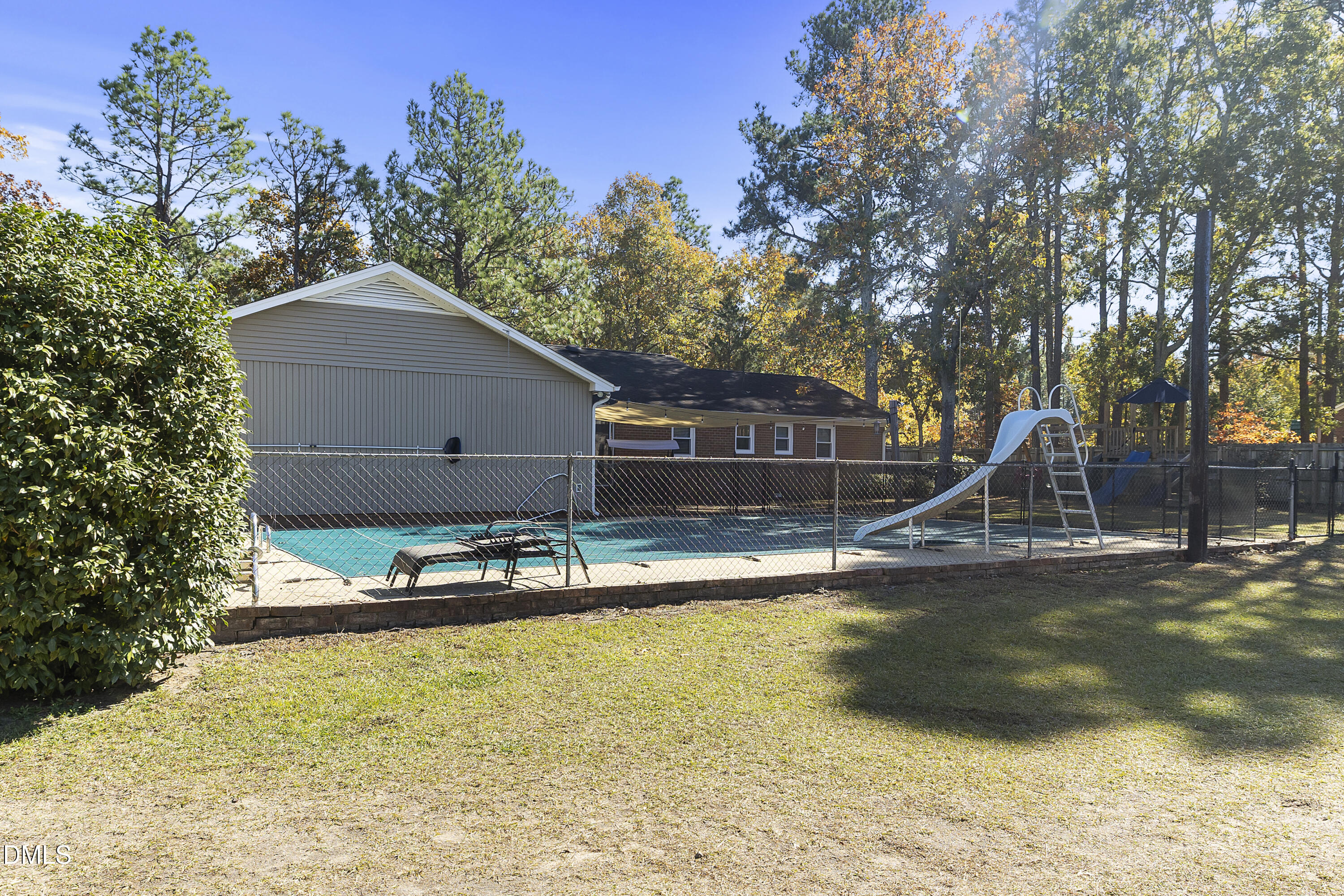 2636 Nicholson Road Cameron, NC 28326 - Photo 12 of 68 a view of a swimming pool with some plants and trees