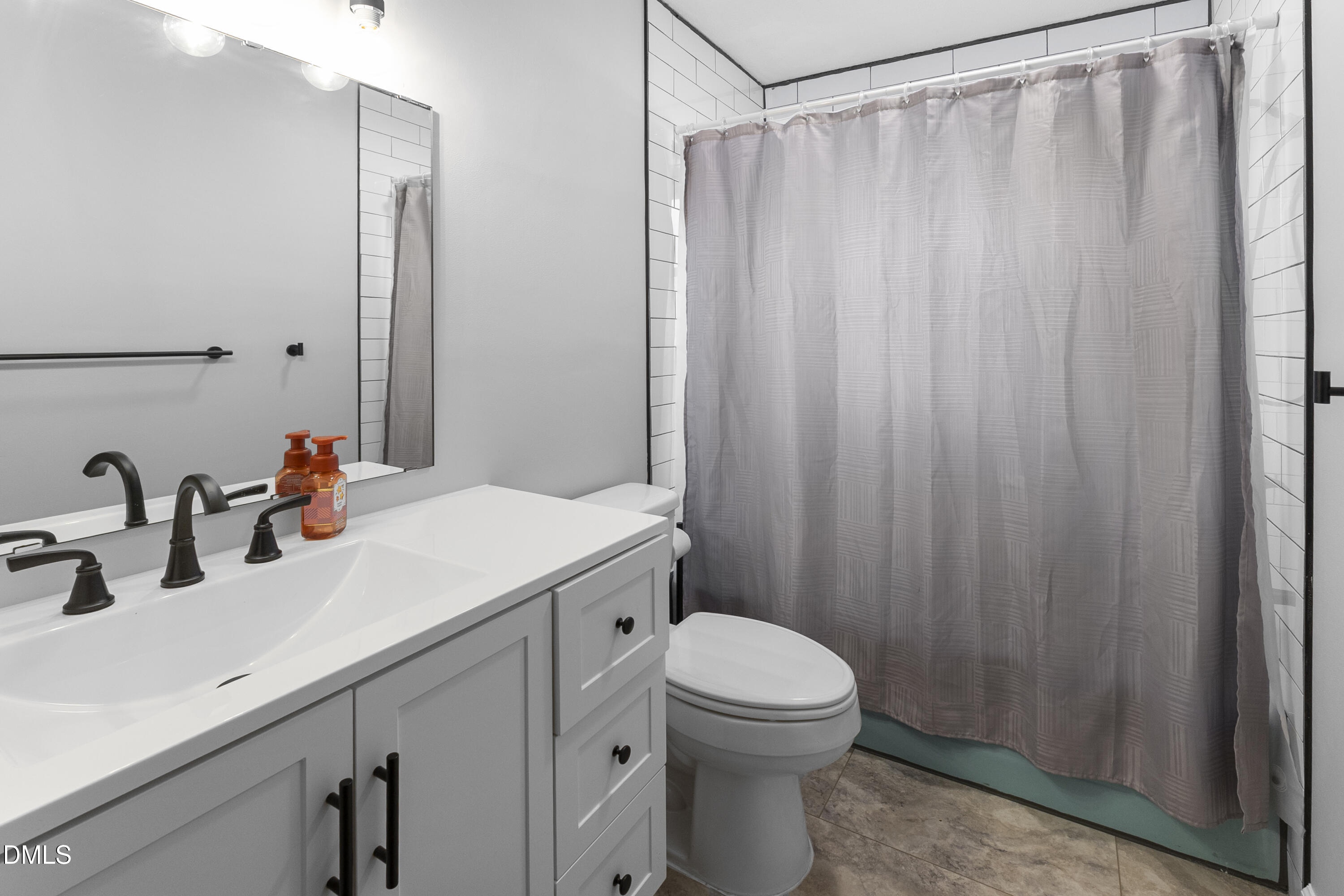 2636 Nicholson Road Cameron, NC 28326 - Photo 21 of 68 a bathroom with a sink a toilet and shower curtain