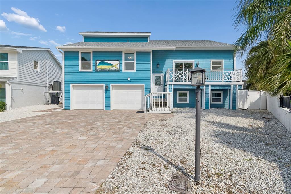 330 6th Avenue Indian Rocks Beach, FL 33785 - Photo 2 of 52 a front view of a house with a yard and garage