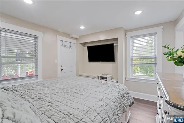 a bathroom with a granite countertop sink a mirror and a shower