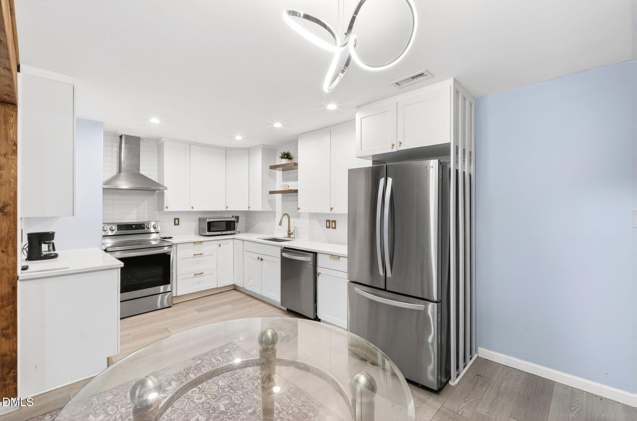 1809 Martin Luther King Jr Boulevard Raleigh, NC 27610 - Photo 10 of 26 a kitchen with stainless steel appliances a refrigerator sink and cabinets