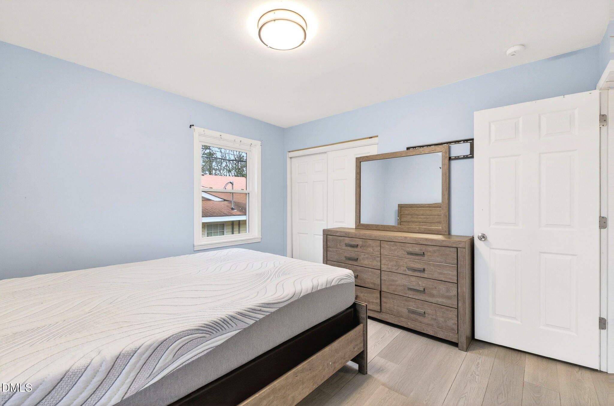 1809 Martin Luther King Jr Boulevard Raleigh, NC 27610 - Photo 19 of 26 a bedroom with a bed and a dresser
