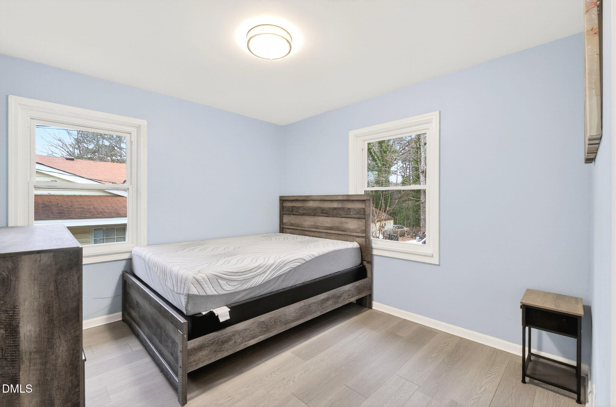 1809 Martin Luther King Jr Boulevard Raleigh, NC 27610 - Photo 21 of 26 a bed sitting in a bedroom next to a window