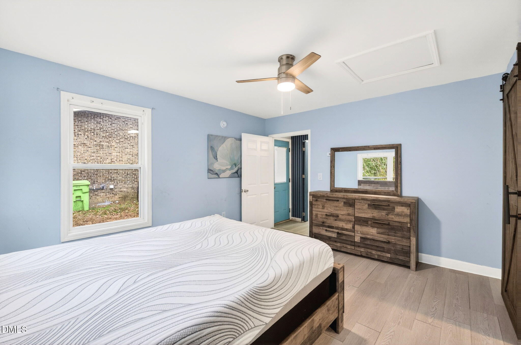 1809 Martin Luther King Jr Boulevard Raleigh, NC 27610 - Photo 22 of 26 a bedroom with a bed cabinets and a window