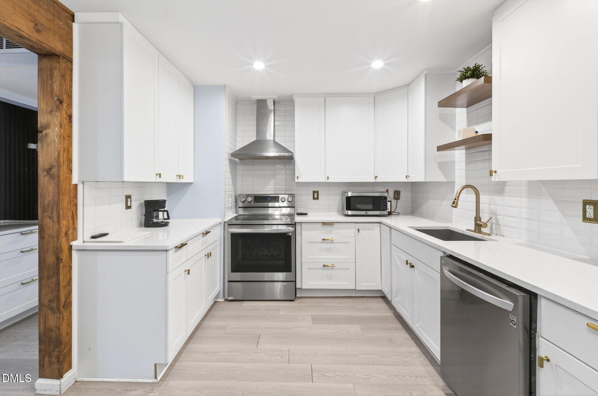 1809 Martin Luther King Jr Boulevard Raleigh, NC 27610 - Photo 9 of 26 a kitchen with stainless steel appliances granite countertop a sink stove and refrigerator