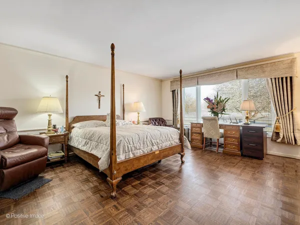 a bedroom with a large bed and a large window