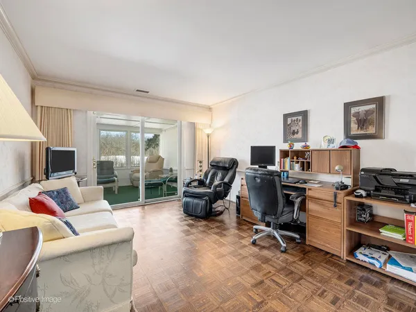 a view of a livingroom with workspace and a couch