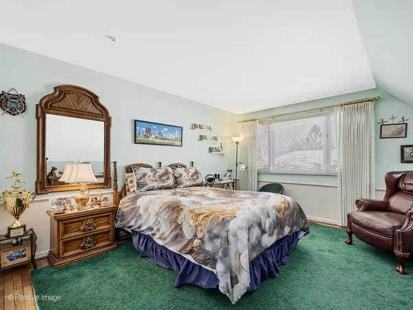a bedroom with a bed and a couch