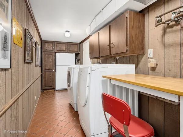 a kitchen with refrigerator and mirror