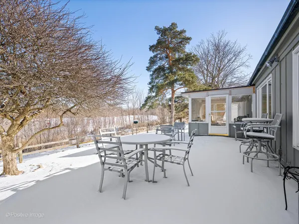 a view of a patio with table and chairs and potted plants