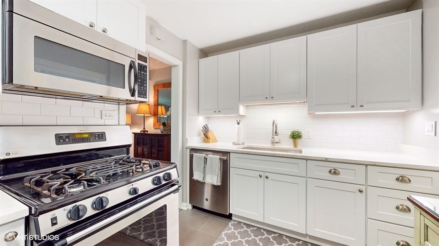 505 3rd Street Wilmette, IL 60091 - Photo 11 of 30 a kitchen with white cabinets and appliances