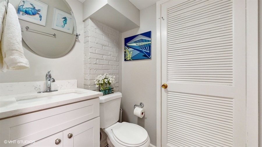 505 3rd Street Wilmette, IL 60091 - Photo 13 of 30 a bathroom with a toilet a sink and mirror