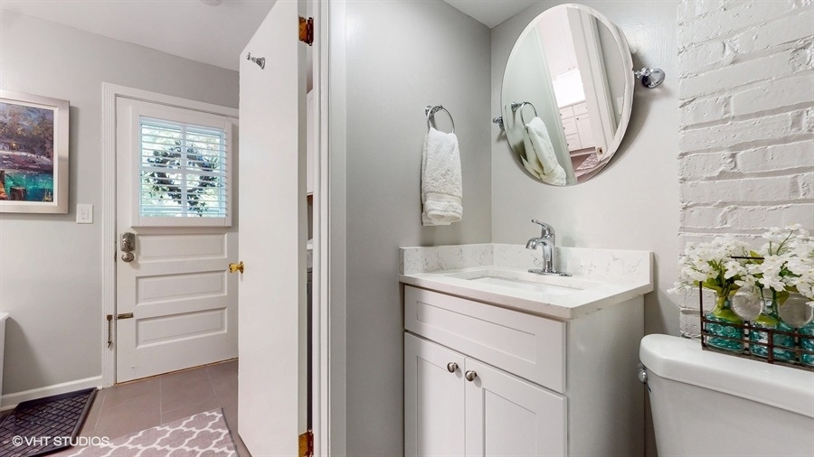 505 3rd Street Wilmette, IL 60091 - Photo 14 of 30 a bathroom with a sink a toilet and a mirror
