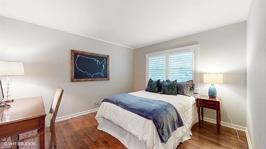 505 3rd Street Wilmette, IL 60091 - Photo 18 of 30 a bedroom with a bed a desk and chair next to a window