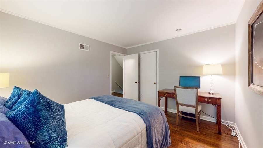 505 3rd Street Wilmette, IL 60091 - Photo 19 of 30 a bedroom with a bed and a lamp on table