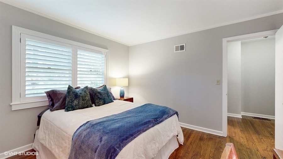 505 3rd Street Wilmette, IL 60091 - Photo 20 of 30 a bedroom with a bed and wooden floor