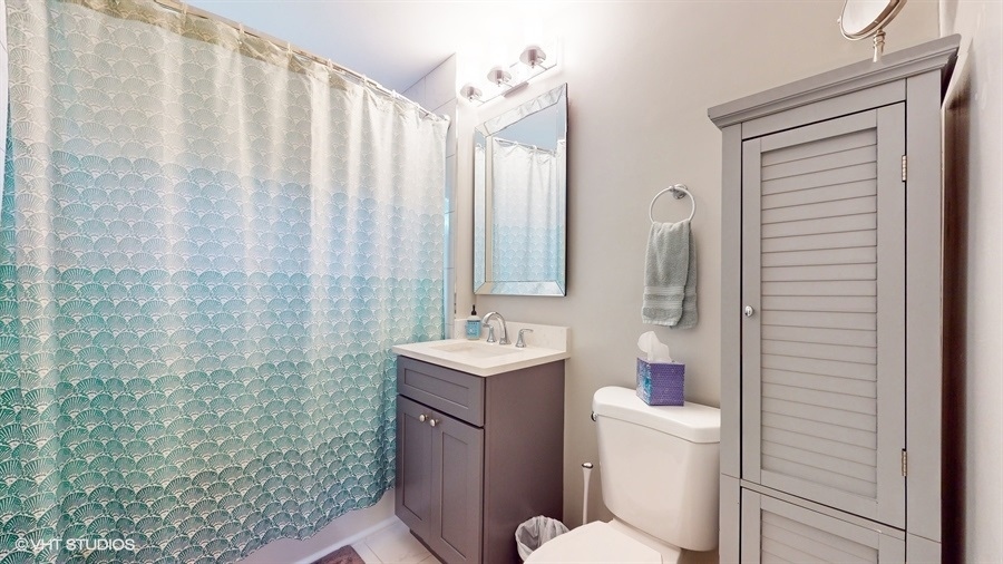505 3rd Street Wilmette, IL 60091 - Photo 21 of 30 a bathroom with a sink a toilet and shower curtain