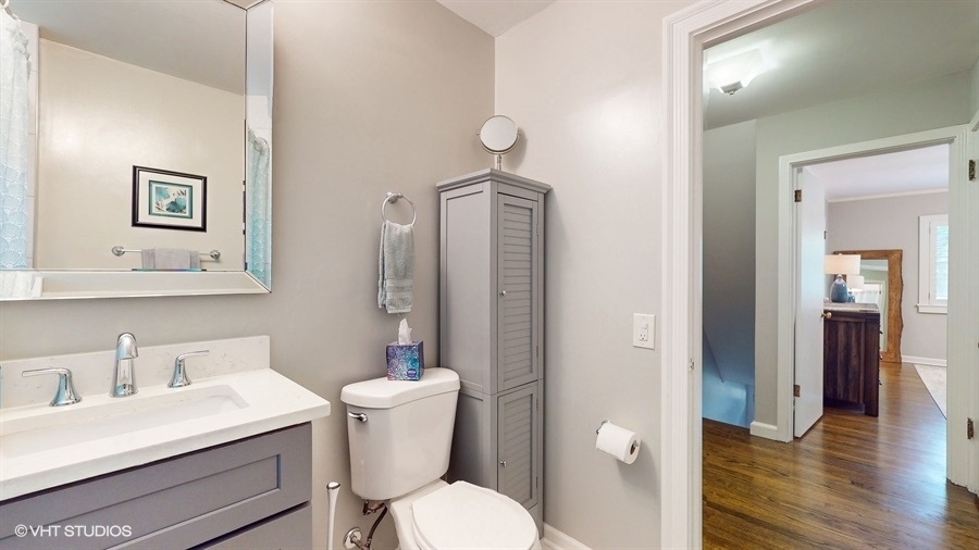 505 3rd Street Wilmette, IL 60091 - Photo 22 of 30 a bathroom with a toilet a sink and mirror
