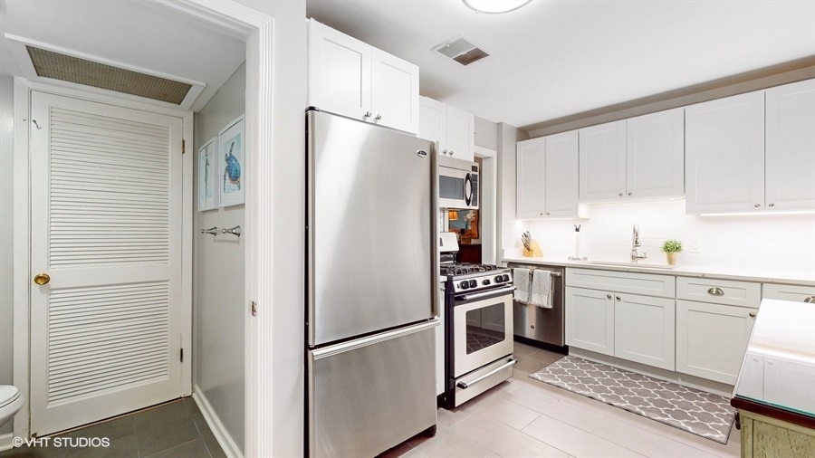 505 3rd Street Wilmette, IL 60091 - Photo 10 of 30 a kitchen with stainless steel appliances a refrigerator sink and cabinets