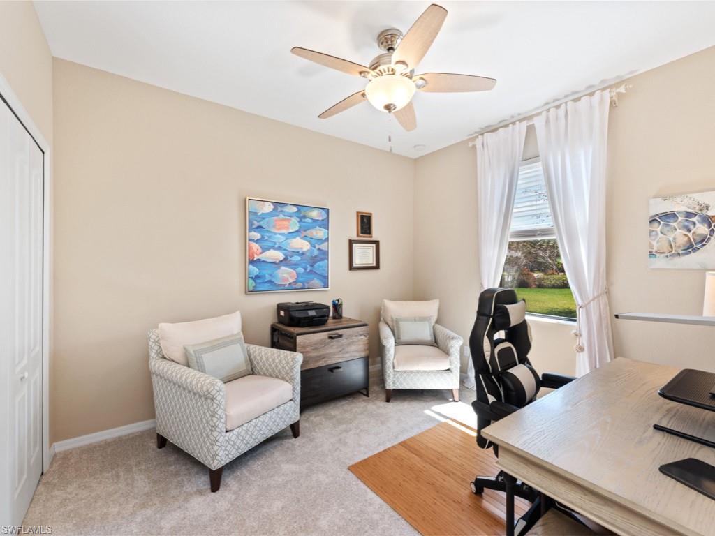 3913 Sapphire Way Naples, FL 34114 - Photo 15 of 32 a living room with furniture a table and a chandelier
