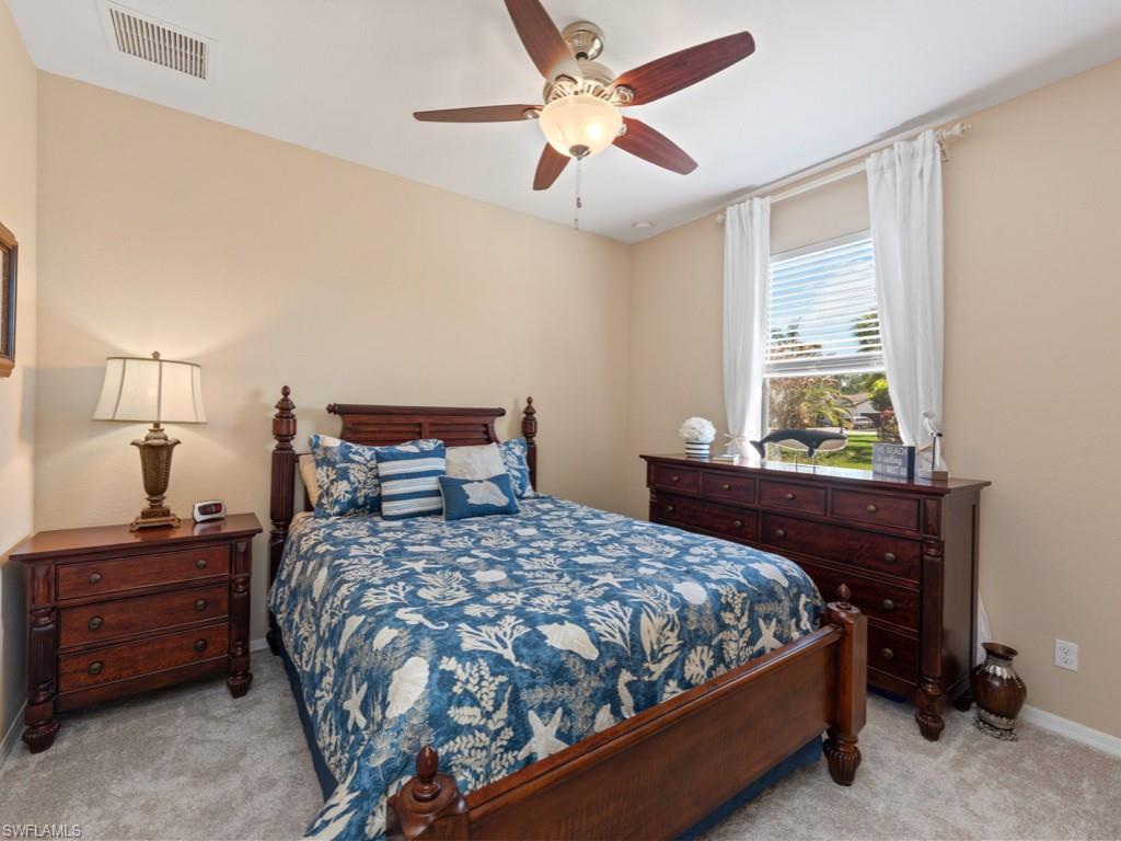 3913 Sapphire Way Naples, FL 34114 - Photo 18 of 32 a bedroom with a bed and a window