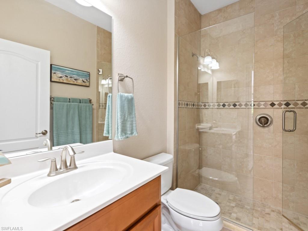 3913 Sapphire Way Naples, FL 34114 - Photo 19 of 32 a bathroom with a sink a toilet and shower
