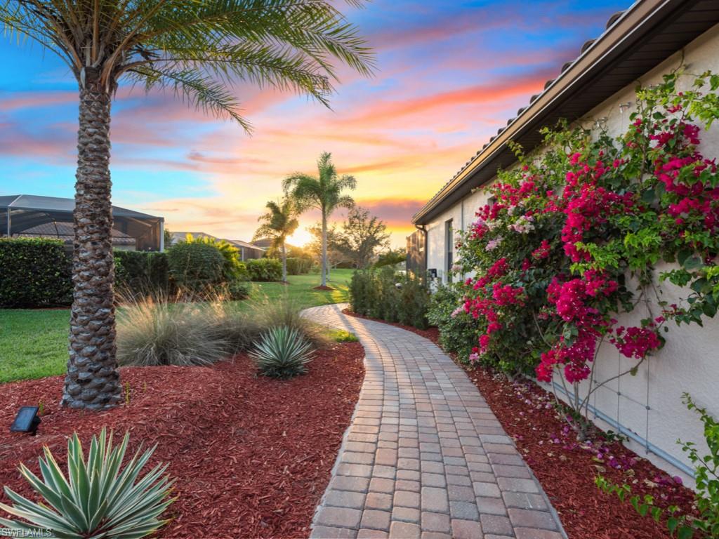 3913 Sapphire Way Naples, FL 34114 - Photo 22 of 32 a backyard of a house with outdoor seating
