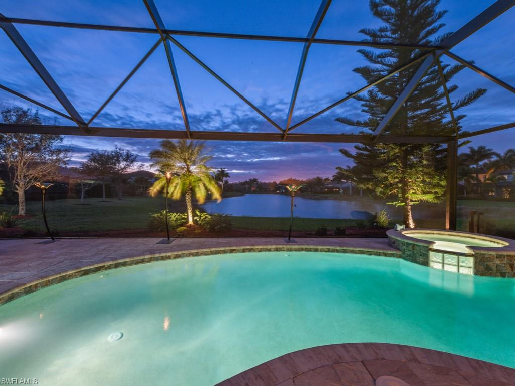 3913 Sapphire Way Naples, FL 34114 - Photo 28 of 32 a view of a backyard with table and chairs under an umbrella