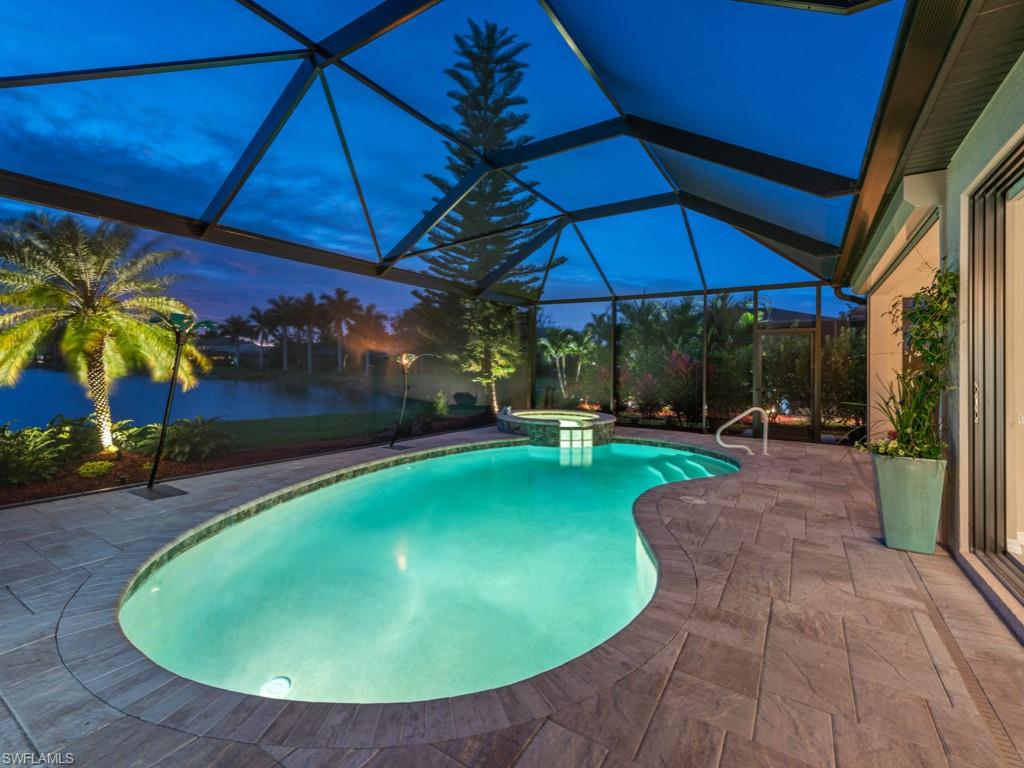 3913 Sapphire Way Naples, FL 34114 - Photo 30 of 32 a view of a backyard with table and chairs under an umbrella