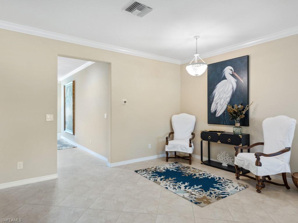 3913 Sapphire Way Naples, FL 34114 - Photo 5 of 32 a living room with furniture and a chandelier