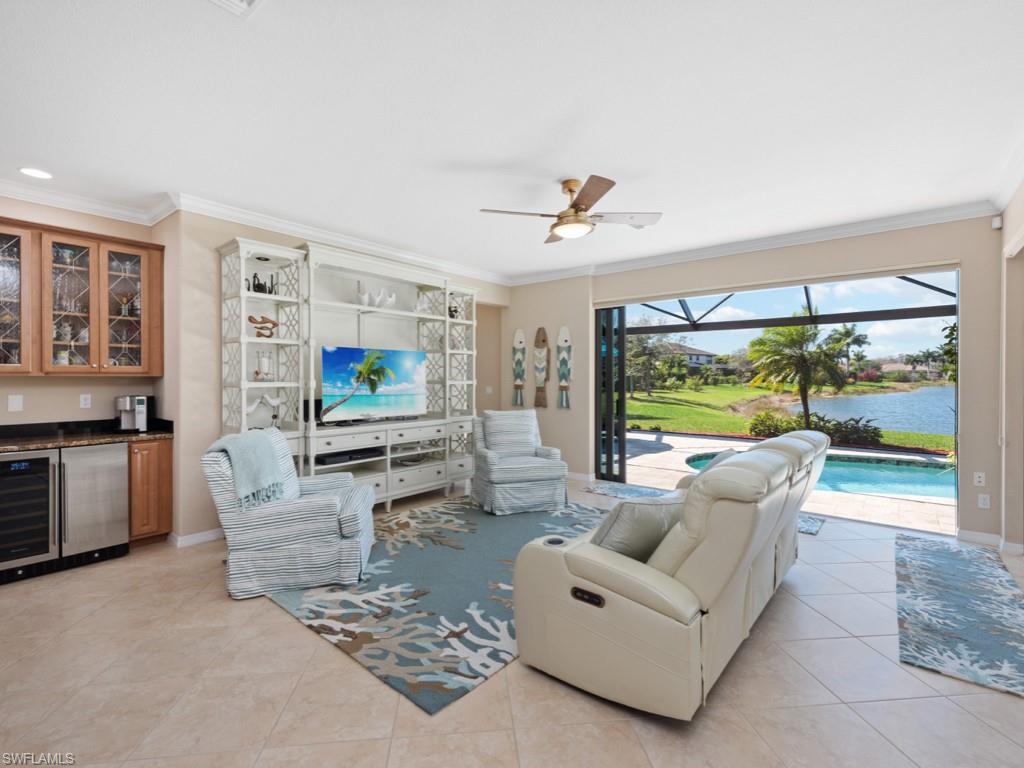 3913 Sapphire Way Naples, FL 34114 - Photo 9 of 32 a living room with furniture and a flat screen tv