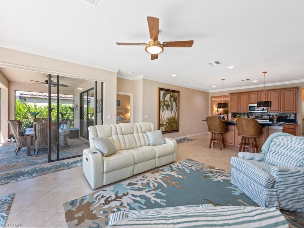 3913 Sapphire Way Naples, FL 34114 - Photo 10 of 32 a living room with furniture and a large window
