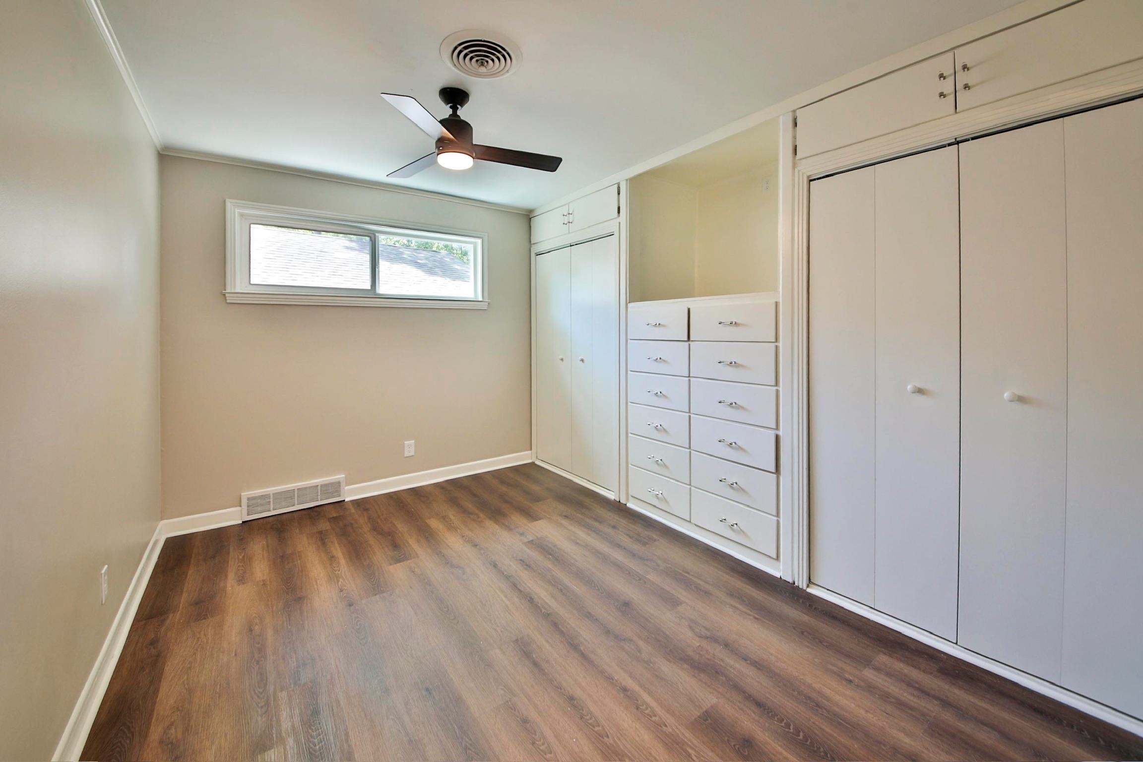 4869 Southern Road Memphis, TN 38117 - Photo 20 of 35 a view of an empty room with wooden floor and a window