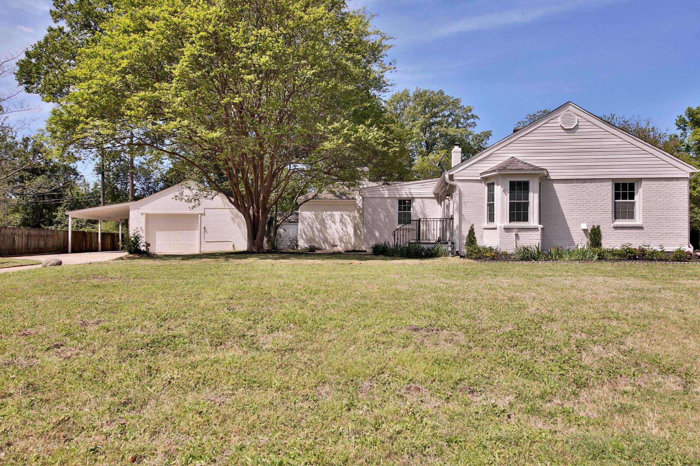 4869 Southern Road Memphis, TN 38117 - Photo 2 of 35 a front view of house with yard and trees around