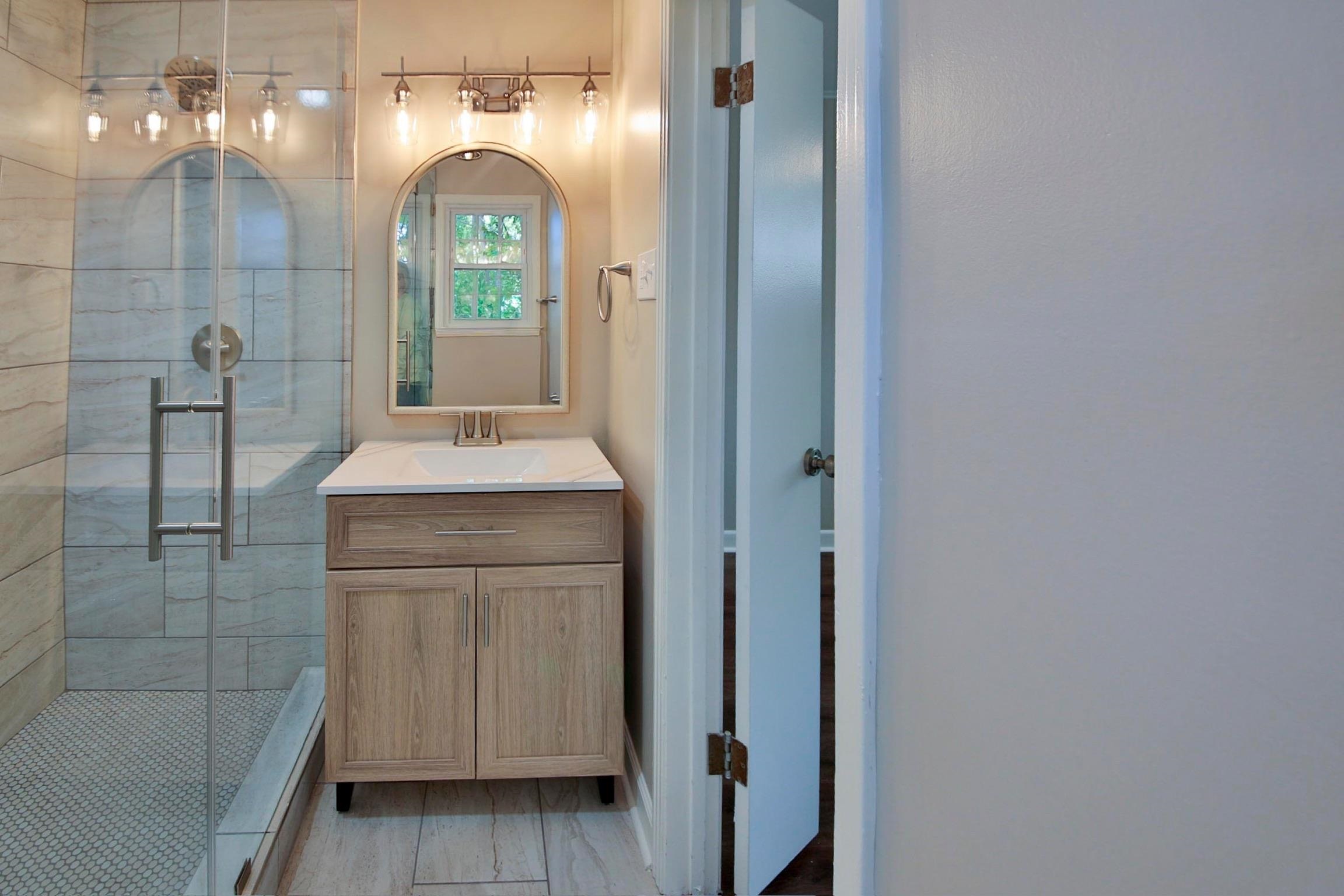 4869 Southern Road Memphis, TN 38117 - Photo 22 of 35 a bathroom with a granite countertop sink a toilet and shower