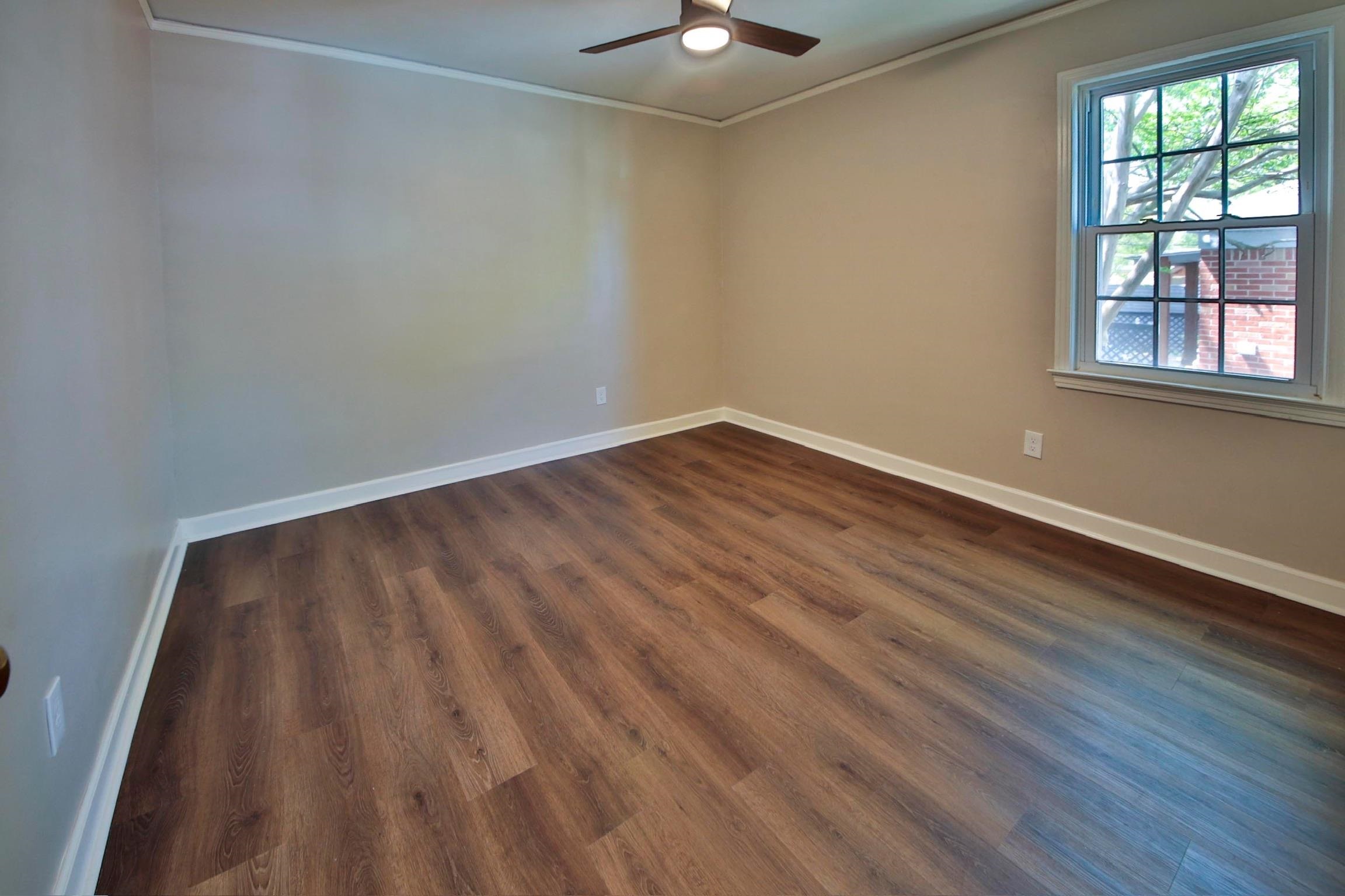 4869 Southern Road Memphis, TN 38117 - Photo 28 of 35 a view of an empty room with wooden floor and a window
