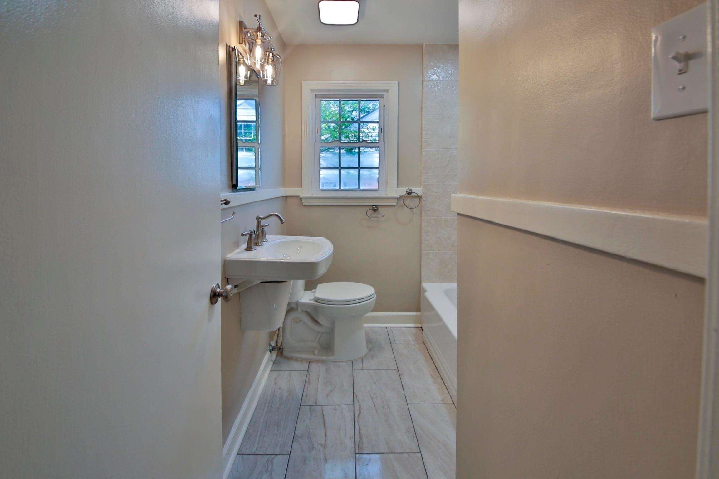 4869 Southern Road Memphis, TN 38117 - Photo 29 of 35 a bathroom with a sink toilet and a mirror