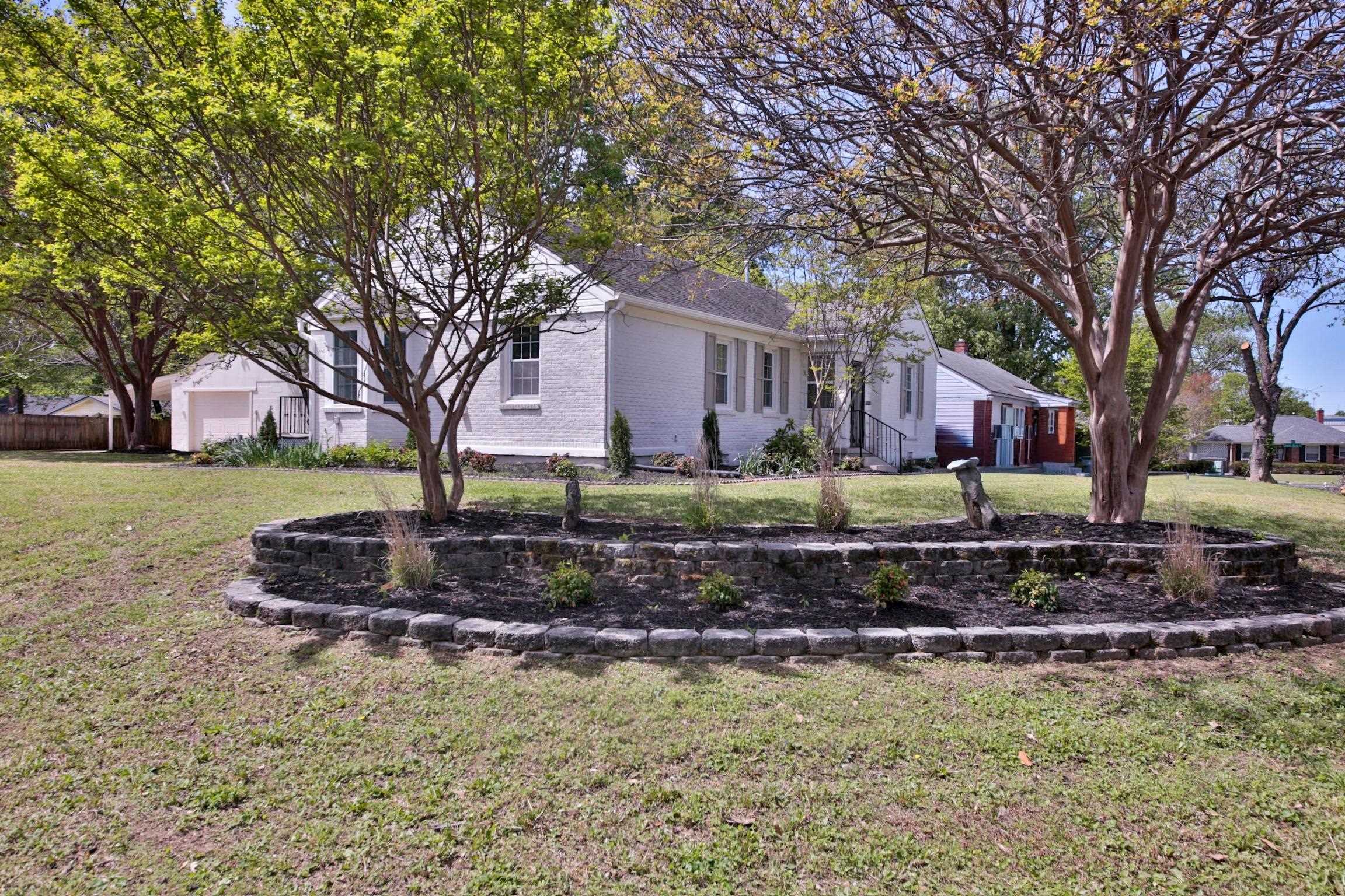 4869 Southern Road Memphis, TN 38117 - Photo 3 of 35 a front view of a house with a yard and trees