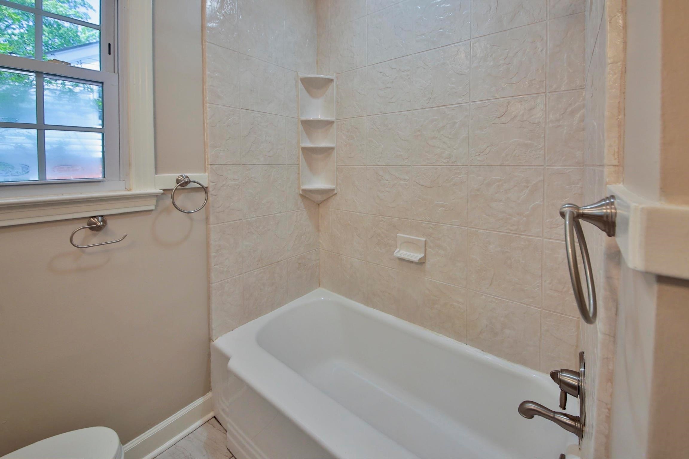 4869 Southern Road Memphis, TN 38117 - Photo 31 of 35 a bathroom with a sink a toilet and shower