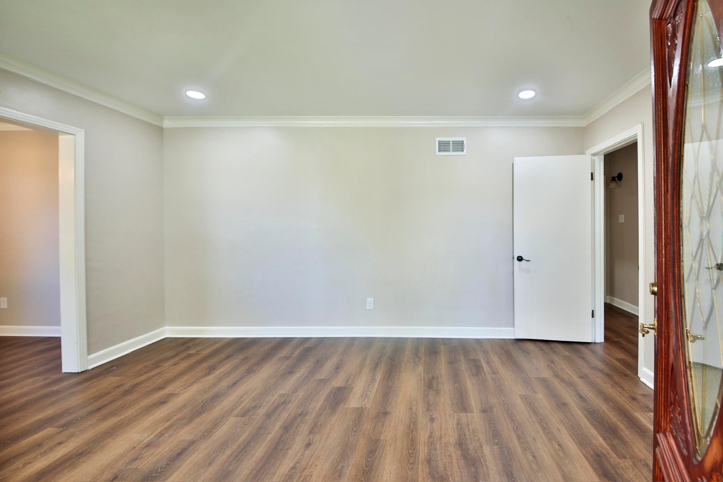 4869 Southern Road Memphis, TN 38117 - Photo 5 of 35 a view of an empty room with wooden floor and a window