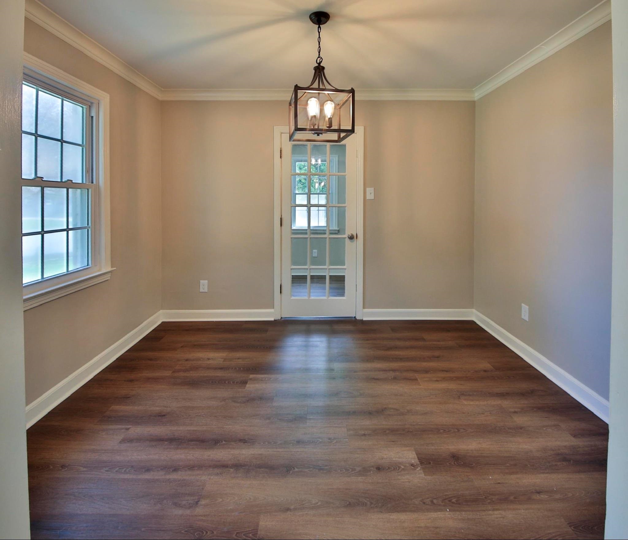 4869 Southern Road Memphis, TN 38117 - Photo 7 of 35 a view of an empty room with wooden floor and a window