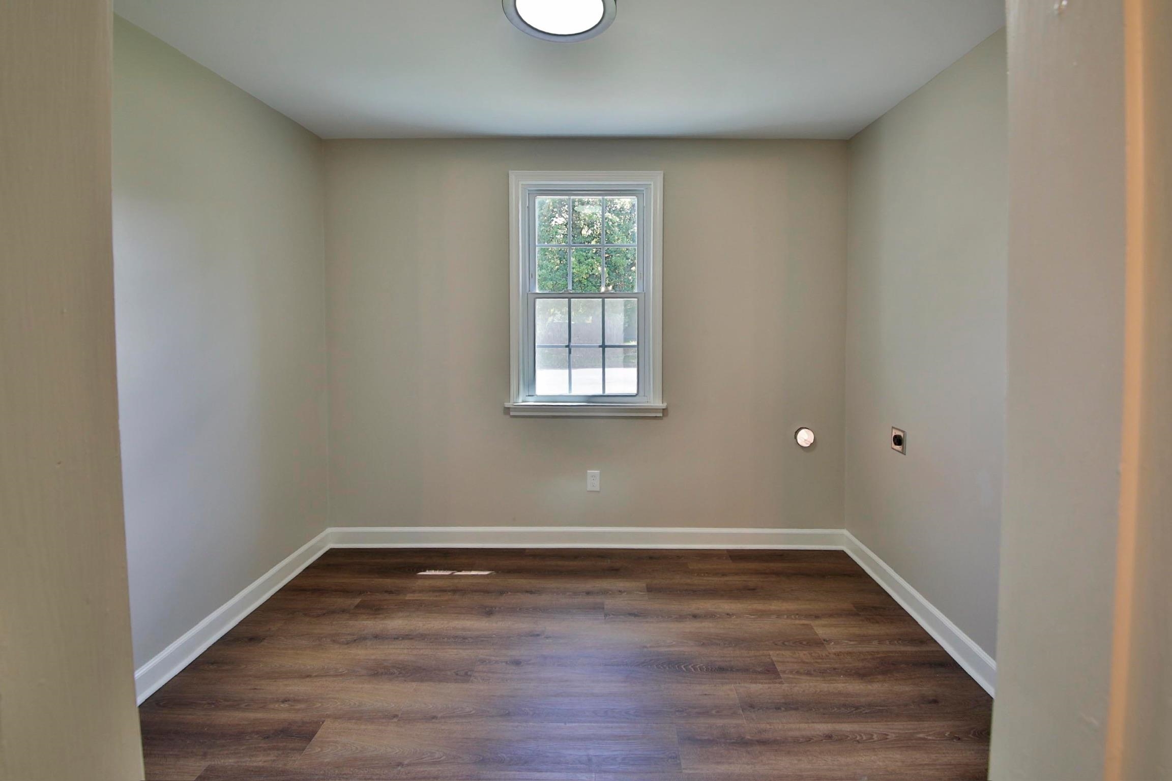 4869 Southern Road Memphis, TN 38117 - Photo 8 of 35 an empty room with wooden floor and windows