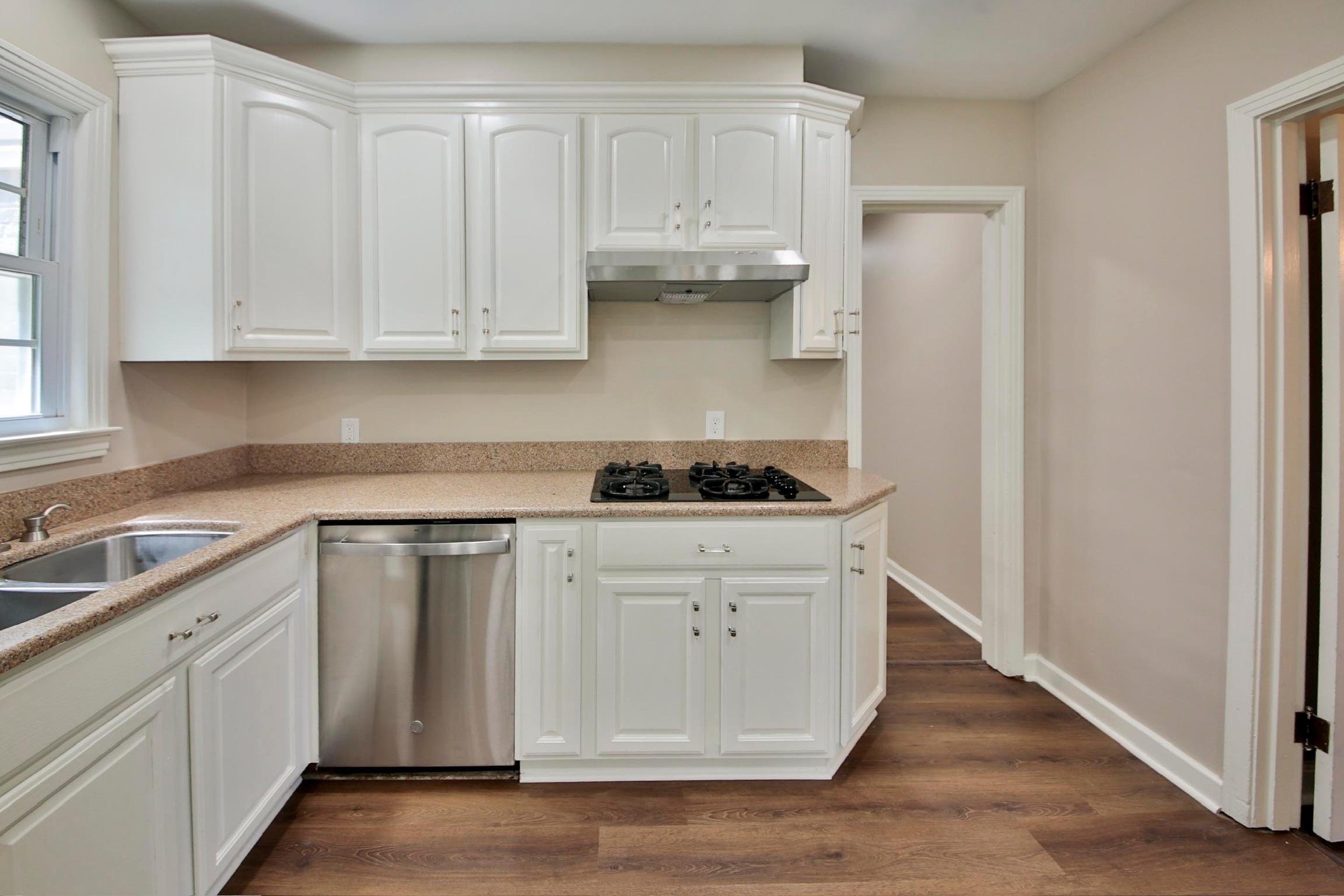4869 Southern Road Memphis, TN 38117 - Photo 10 of 35 a kitchen with white cabinets and white appliances
