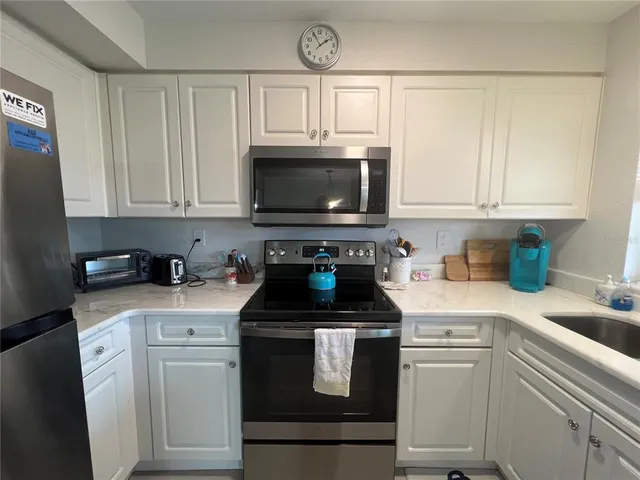 a kitchen with a stove and a microwave