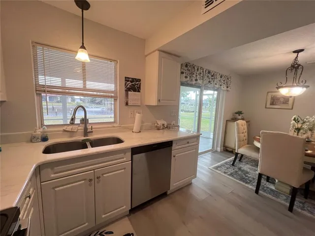 a kitchen with sink refrigerator and window